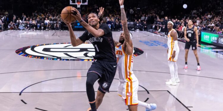 Brooklyn Nets forward Ziaire Williams shoots the ball over Atlanta Hawks guard Nickeil Alexander-Walker.