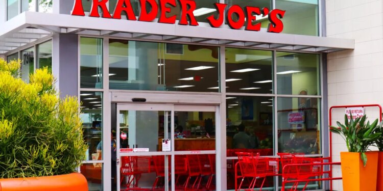 Exterior of a Trader Joe's grocery store with red shopping carts outside the entrance.