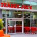 Exterior of a Trader Joe's grocery store with red shopping carts outside the entrance.