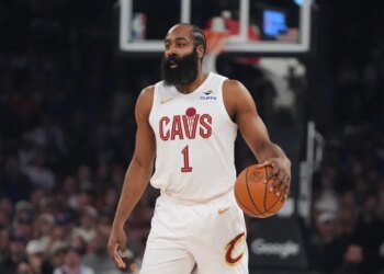 James Harden holding a basketball during an NBA game.