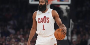 James Harden holding a basketball during an NBA game.