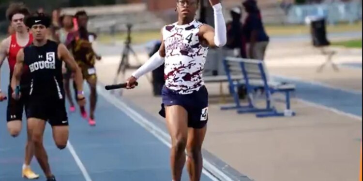 Track athlete Nyan Brown raising his hand in celebration as he crosses the finish line, costing his team a championship due to the gesture.