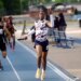 Track athlete Nyan Brown raising his hand in celebration as he crosses the finish line, costing his team a championship due to the gesture.