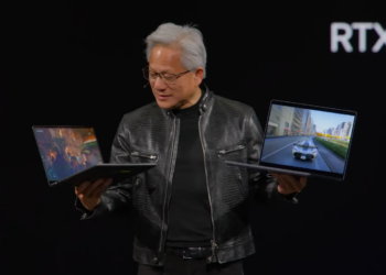 Nvidia’s CEO holds up two RTX Spark laptops at Computex.