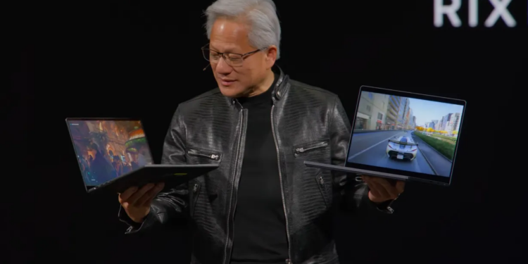 Nvidia’s CEO holds up two RTX Spark laptops at Computex.