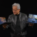 Nvidia’s CEO holds up two RTX Spark laptops at Computex.