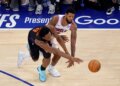 New York Knicks forward Og Anunoby (8) knocks the ball away from Philadelphia 76ers forward Paul George (8).