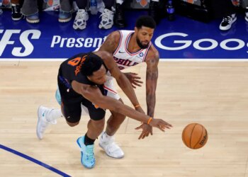 New York Knicks forward Og Anunoby (8) knocks the ball away from Philadelphia 76ers forward Paul George (8).