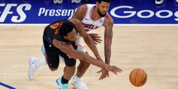 New York Knicks forward Og Anunoby (8) knocks the ball away from Philadelphia 76ers forward Paul George (8).
