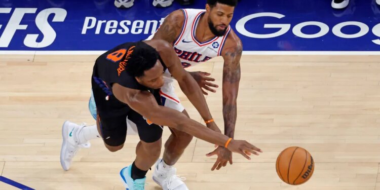 New York Knicks forward Og Anunoby (8) knocks the ball away from Philadelphia 76ers forward Paul George (8).