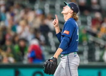 Seattle Mariners pitcher Bryce Miller celebrates after winning a baseball game.