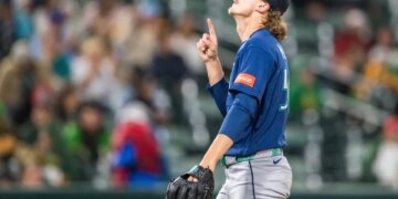 Seattle Mariners pitcher Bryce Miller celebrates after winning a baseball game.