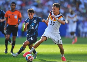 Germany's Florian Wirtz and Paraguay's Andres Cubas battle for the ball during a World Cup match.