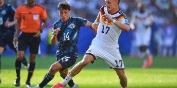 Germany's Florian Wirtz and Paraguay's Andres Cubas battle for the ball during a World Cup match.