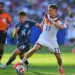 Germany's Florian Wirtz and Paraguay's Andres Cubas battle for the ball during a World Cup match.