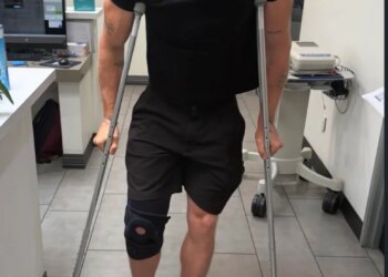 A person with a knee brace and crutches.