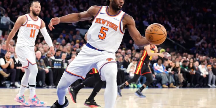 New York Knicks forward Precious Achiuwa rebounds the ball during the first quarter.