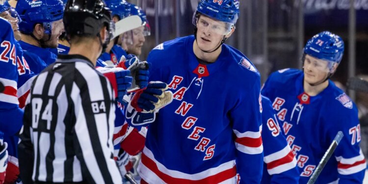 New York Rangers center Adam Edstrom (84) celebrates his goal with the team in the second period against the New Jersey Devils at Madison Square Garden, Thursday, Oct. 2, 2025, in New York, NY.