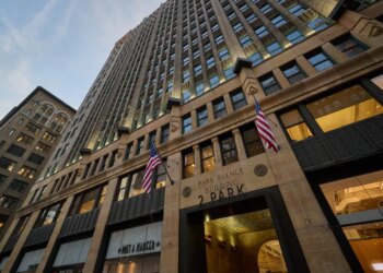 The Park Avenue Building at 2 Park Avenue, with flags outside the building.