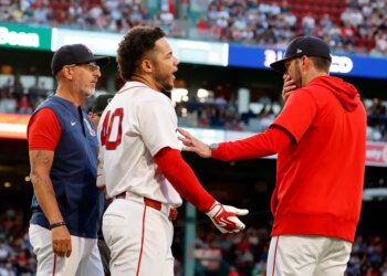 Boston Red Sox interim manager Chad Tracy holds back Willson Contreras after Contreras was ejected for contesting a call.