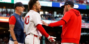 Boston Red Sox interim manager Chad Tracy holds back Willson Contreras after Contreras was ejected for contesting a call.