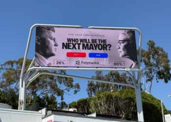 A digital billboard showing Spencer Pratt and Karen Bass with their Polymarket odds for "Who will be the next mayor?".