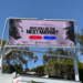 A digital billboard showing Spencer Pratt and Karen Bass with their Polymarket odds for "Who will be the next mayor?".