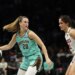 New York Liberty guard Sabrina Ionescu dribbling the ball while defended by Washington Mystics guard Sonia Citron.