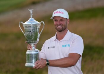 Wyndham Clark holds the trophy after winning the U.S. Open golf tournament at Shinnecock Hills Golf Club in Southampton, N.Y., Sunday, June 21, 2026.