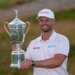 Wyndham Clark holds the trophy after winning the U.S. Open golf tournament at Shinnecock Hills Golf Club in Southampton, N.Y., Sunday, June 21, 2026.