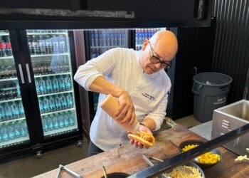 Executive sous chef Camilo Baquero prepares the fried Ripper Hot Dog with pineapple salsa, ketchup mayo, diced pineapple and potato sticks.