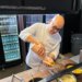 Executive sous chef Camilo Baquero prepares the fried Ripper Hot Dog with pineapple salsa, ketchup mayo, diced pineapple and potato sticks.