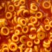 Close-up overhead view of Spaghettio's, a canned pasta consisting of ring-shaped pasta in tomato sauce.