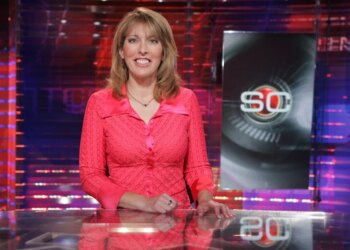 Linda Cohn standing at an anchor desk in front of a SportsCenter logo.