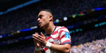 United States' Sergino Dest claps after being substituted during a soccer match.
