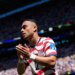 United States' Sergino Dest claps after being substituted during a soccer match.