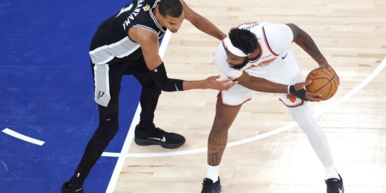 San Antonio Spurs forward Victor Wembanyama (1) defends against New York Knicks center Mitchell Robinson (23) during the first quarter of Game 4.