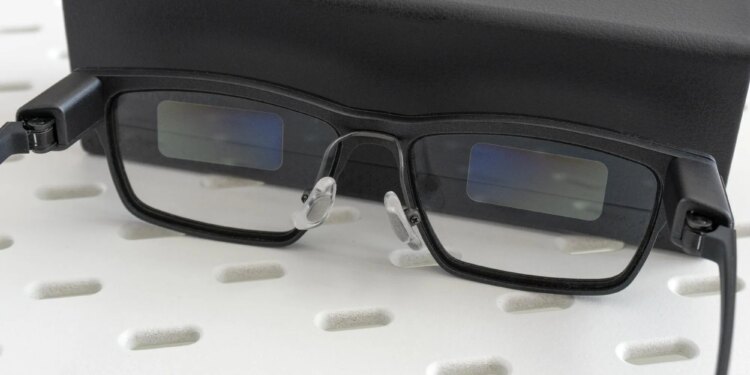 The Xgimi MemoMind One smart glasses leaning against their carrying case.
