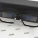 The Xgimi MemoMind One smart glasses leaning against their carrying case.