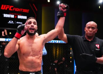 A referee raising Ismael Bonfim's arm in victory at UFC Fight Night: Bonfim vs Brown.