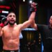 A referee raising Ismael Bonfim's arm in victory at UFC Fight Night: Bonfim vs Brown.