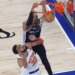 San Antonio Spurs player Victor Wembanyama (1) dunks the ball over New York Knicks player Karl-Anthony Towns (32) during the first quarter.