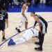 New York Knicks player Karl-Anthony Towns (32) lays on the floor after being fouled by San Antonio Spurs player Victor Wembanyama (1) during the third quarter of Game 4 of the 2026 NBA Finals.