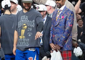 Jalen Brunson and Walt Frazier of the New York Knicks celebrate after winning the NBA Finals.