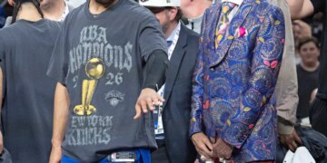 Jalen Brunson and Walt Frazier of the New York Knicks celebrate after winning the NBA Finals.
