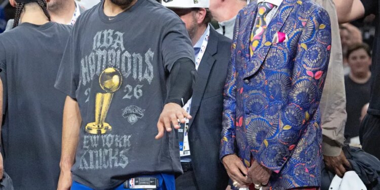 Jalen Brunson and Walt Frazier of the New York Knicks celebrate after winning the NBA Finals.