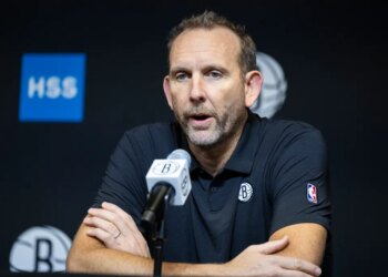 Brooklyn Nets GM Sean Marks speaks into a microphone during post-season interviews.