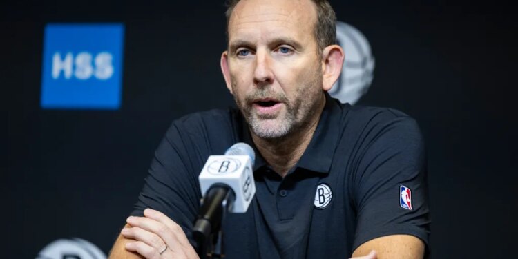 Brooklyn Nets GM Sean Marks speaks into a microphone during post-season interviews.