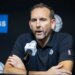 Brooklyn Nets GM Sean Marks speaks into a microphone during post-season interviews.