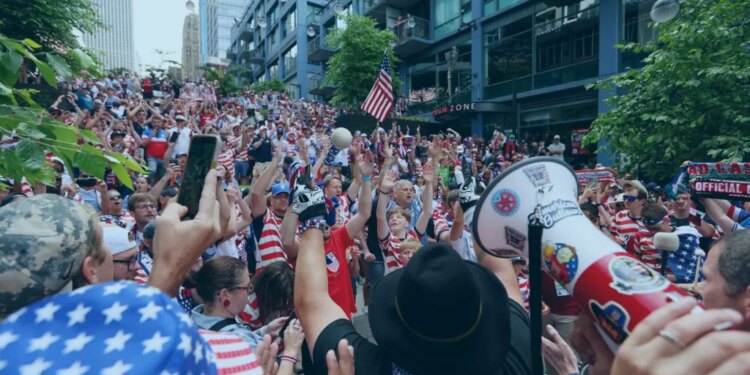An image collage containing 1 images, Image 1 shows Crowds of fans dressed in red, white, and blue, wave their hands in the air and cheer for the US soccer team in Seattle